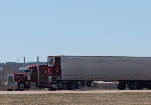 A large semi truck driving down a highway